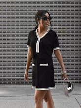 a lady wears black acetate crop top and skirt